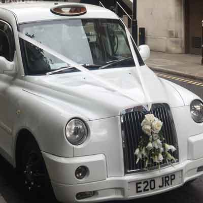 White London Cab with wedding ribbons.