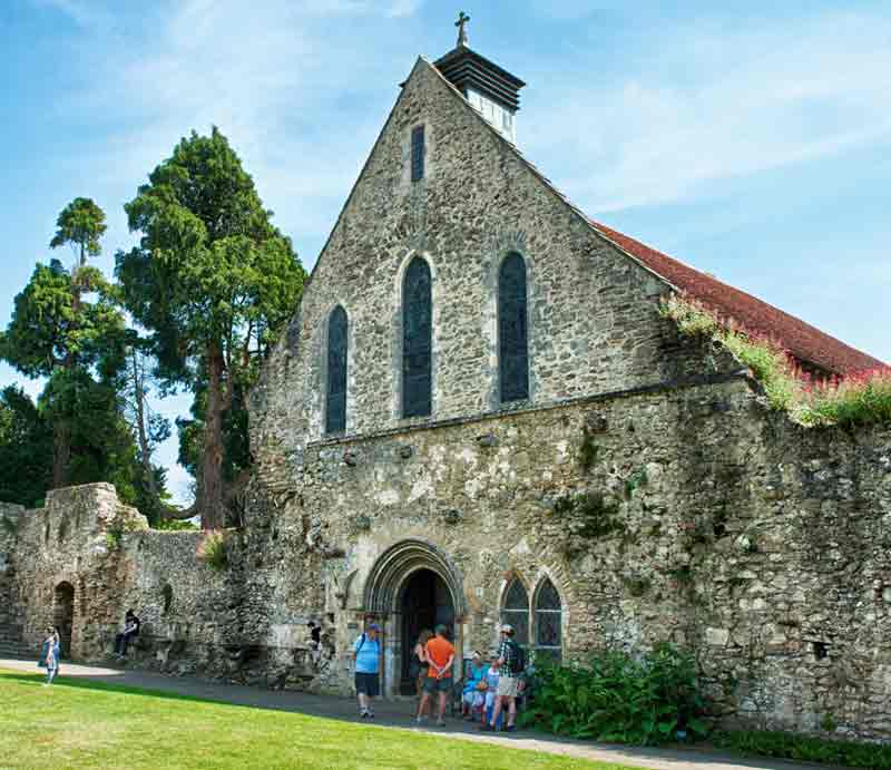 Beaulieu Abbey Visitors viewing the stone-built medieval refectory.