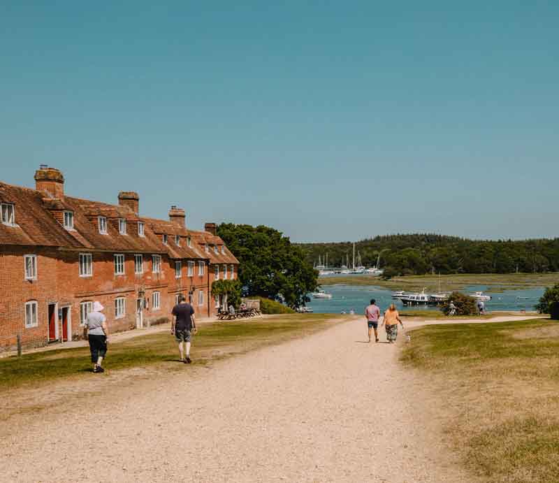 Buckler Red-brick fisherman's cottages along causeway down to the sea.