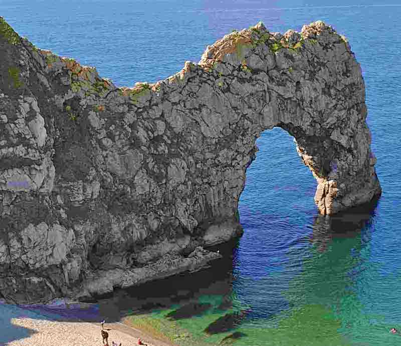 Natural limestone arch jutting out into the sea.