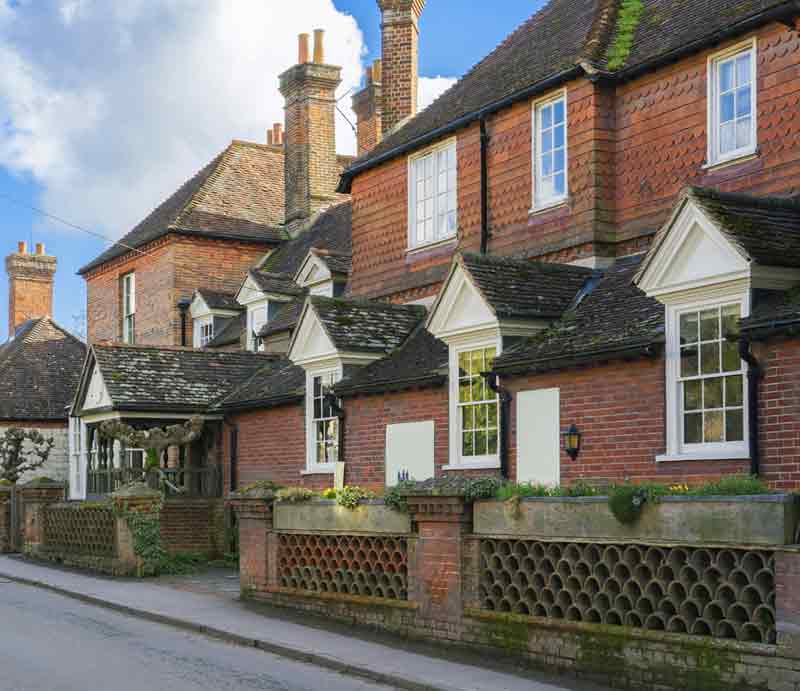 Red brickwork with tile hanging on the upper floor and gabled entrance porch.