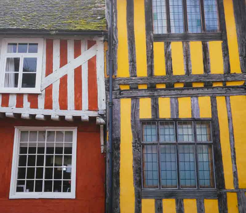 Timber framed houses painted red and yellow.