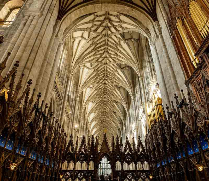 Winchester Cathedral interior Medieval vaulted ceiling, stone columns and intricately carved woodwork.