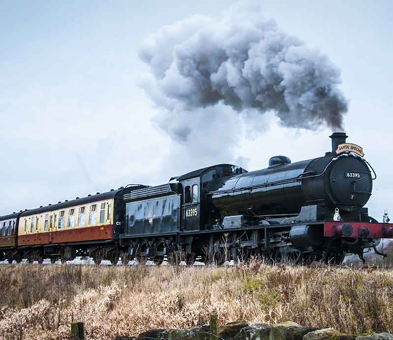 Steam train with carriages crossing the moors.