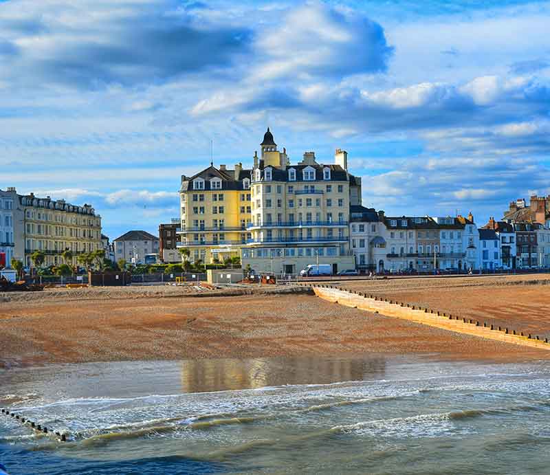 The beach and promenade with Victorian hotel.
