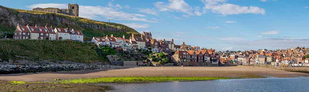 Whitby Harbour with the Gothic abbey atop the cliff.