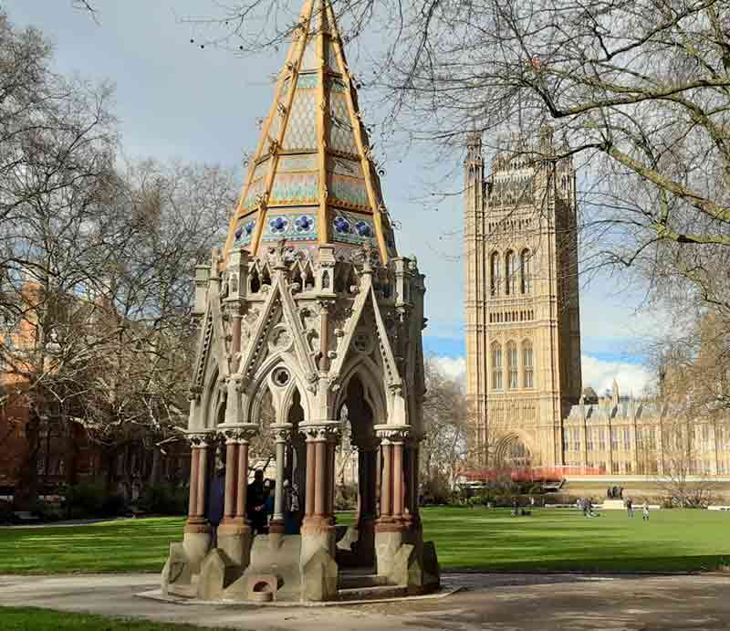 Octagonal neo-Gothic constuction with open arches and granite basins.