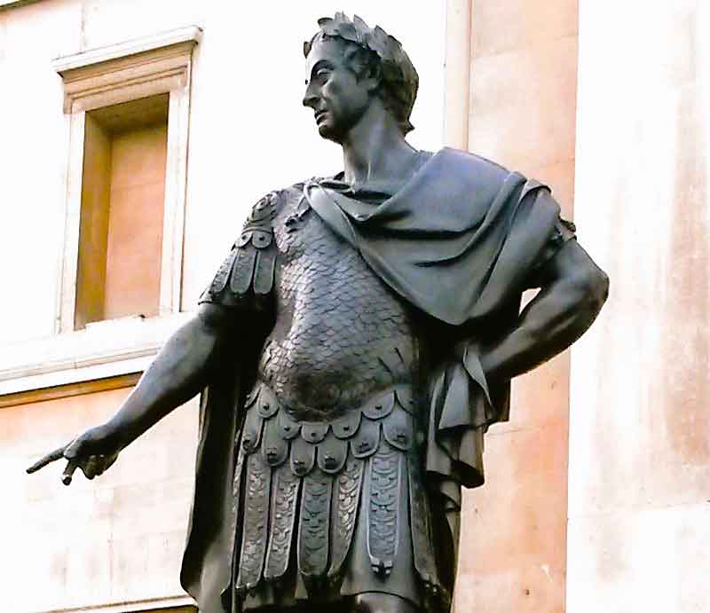 As a Roman emperor, wearing Roman armour and a laurel wreath.