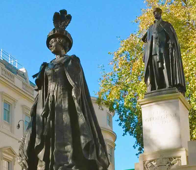 Dark bronze in ceremonial robes with George V1 in the background.