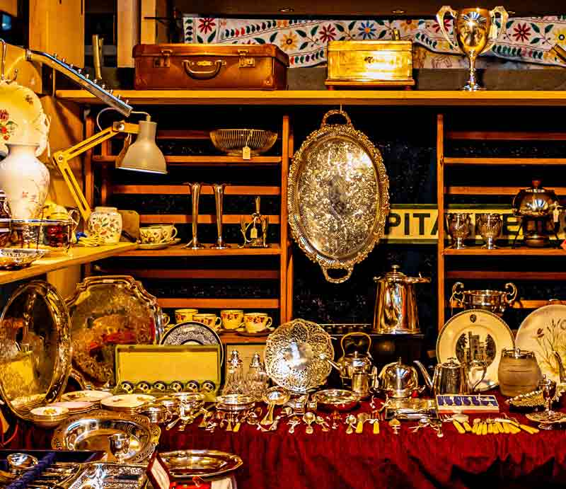 Antiques stall packed with items for sale.