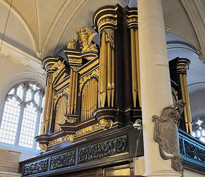 Ornate gold coloured pipes with carved oak.