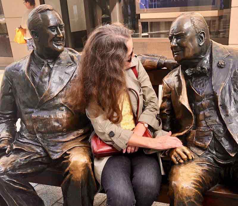 Guest sat between the bronze statues.