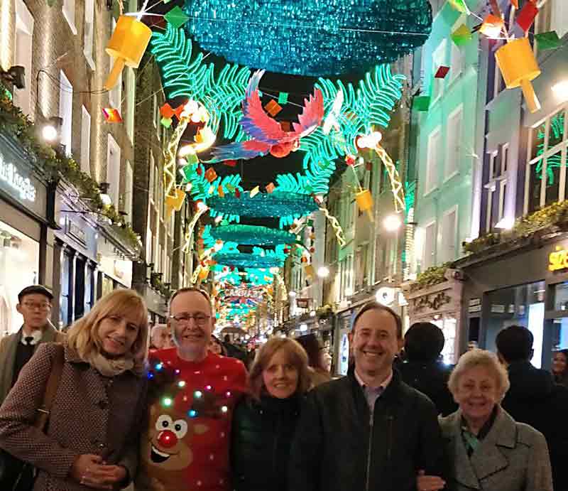 Carnaby Street at Christmas Guests beneath the illuminations.