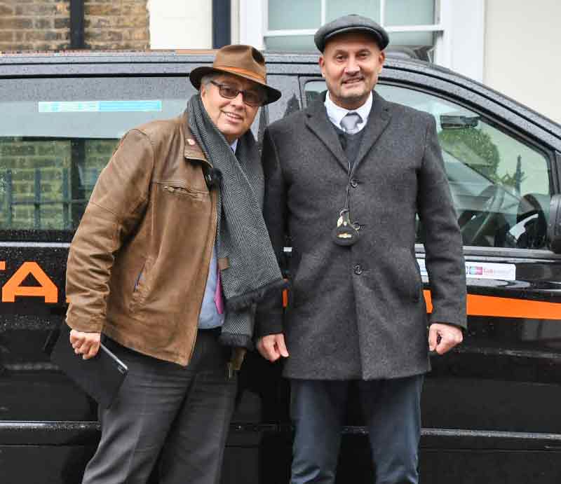 Rob Woodford and Brian White Standing by the taxi.