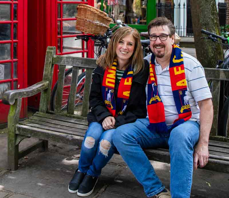 Seated guests wearing AFC Richmond scarves.