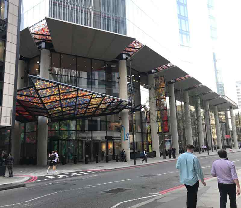 Ground level with colourful glass entrance.