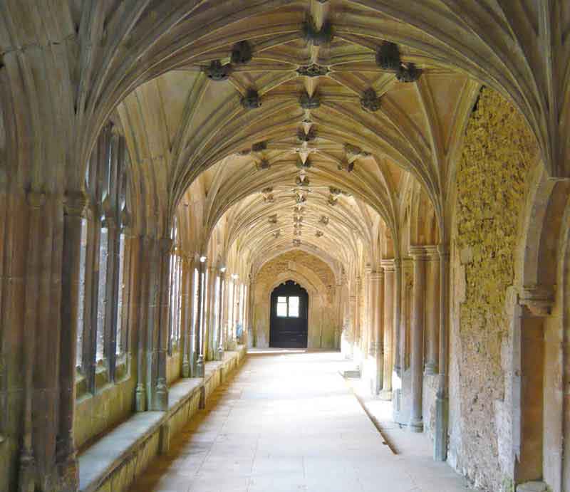 Looking down the sunlit cloisters.