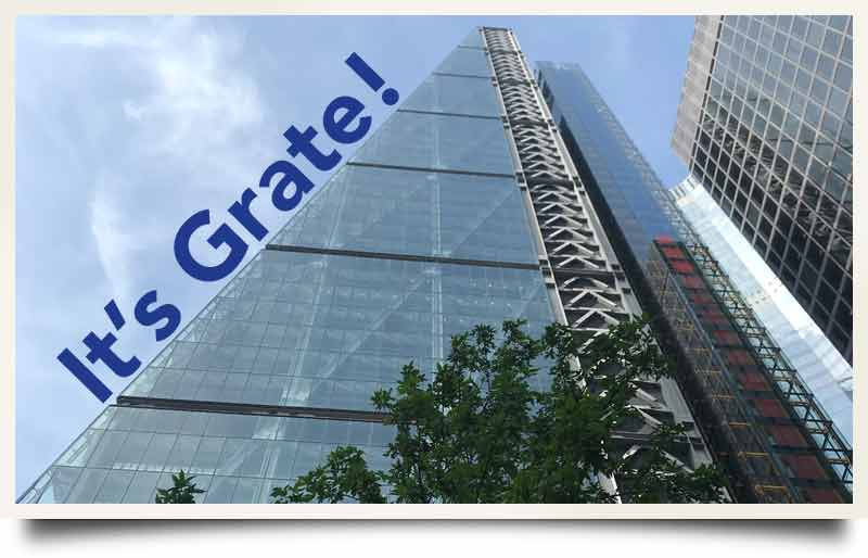 Towering glass wedge-shaped exterior with caption 'It's Grate!'.