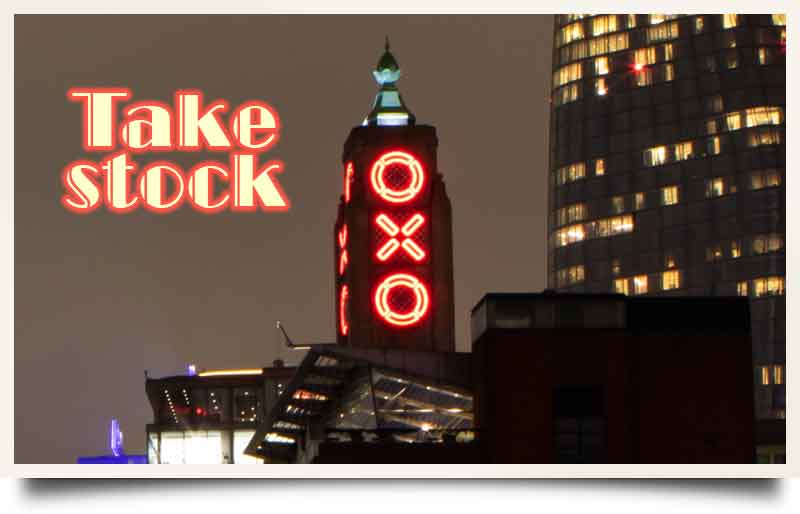 Illuminated at night with caption 'Take stock' in an art deco font.