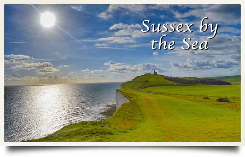 Coastline from atop cliffs with caption 'Sussex by the sea'