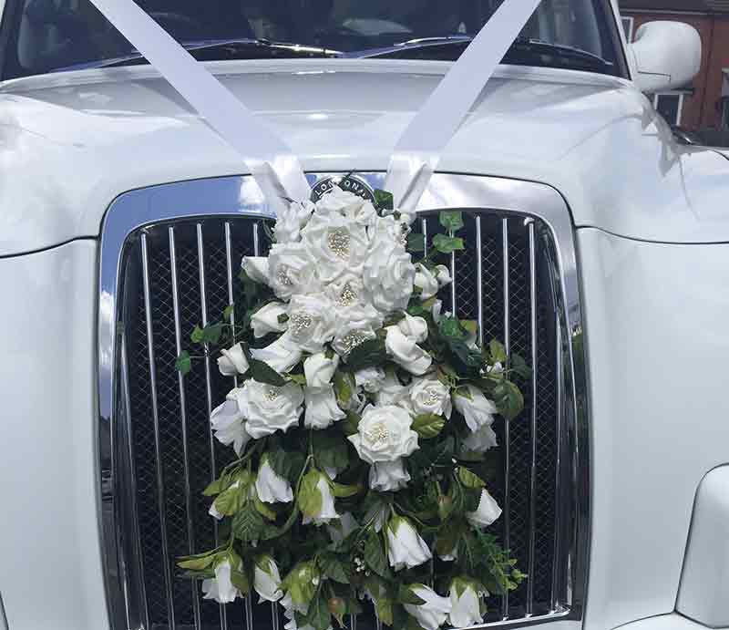 Bouquet of white flowers on the front grill.